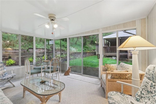 sunroom / solarium featuring ceiling fan