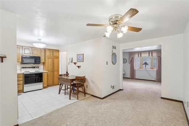 kitchen with light countertops, ceiling fan, black microwave, baseboards, and electric range