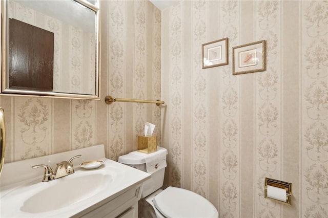 half bath featuring toilet and vanity