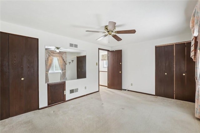 unfurnished bedroom featuring baseboards, visible vents, and carpet