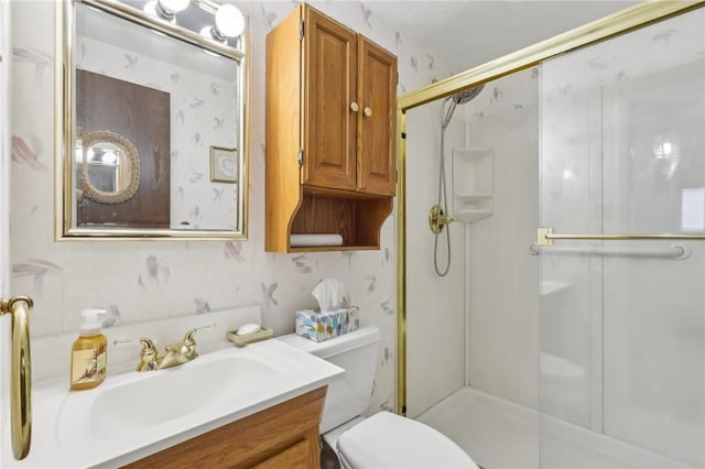 full bathroom with toilet, vanity, and a shower stall