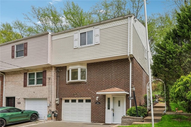 view of property featuring driveway, an attached garage, and brick siding