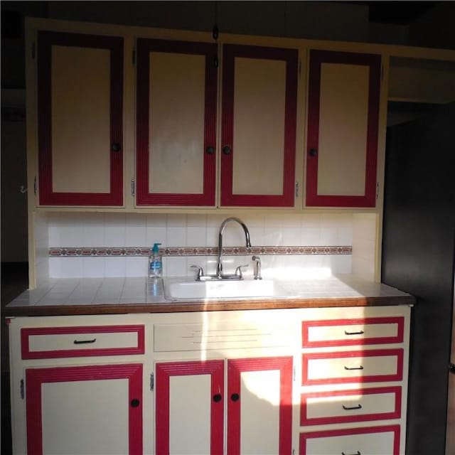 kitchen featuring decorative backsplash and a sink