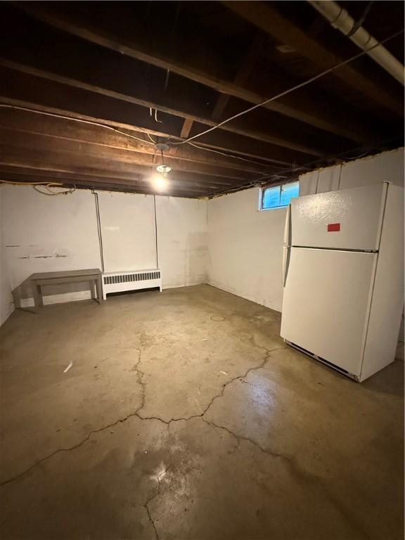 318 Hamburg Rd, Hempfield Twp Mer, PA 16125 - below grade area with radiator heating unit and freestanding refrigerator