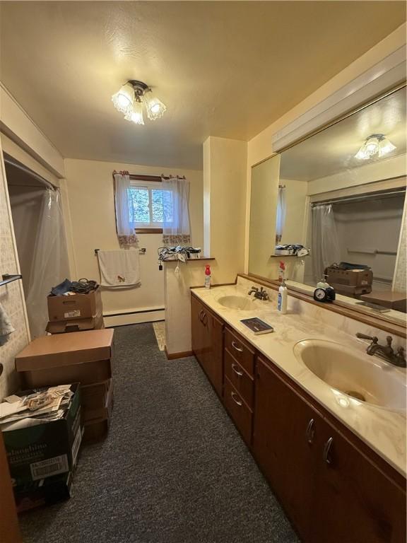 318 Hamburg Rd, Hempfield Twp Mer, PA 16125 - full bath featuring a baseboard heating unit, double vanity, and a sink