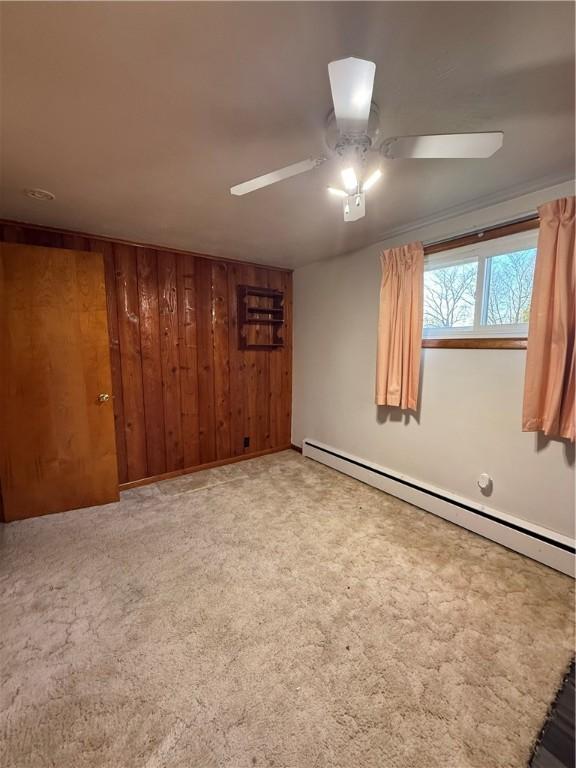 318 Hamburg Rd, Hempfield Twp Mer, PA 16125 - interior space with a baseboard heating unit, ceiling fan, and wood walls