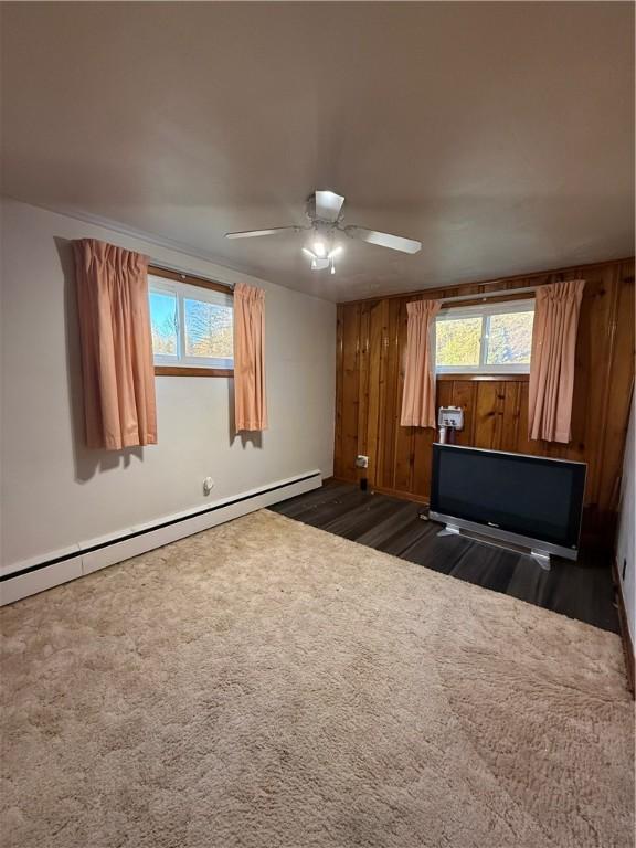 318 Hamburg Rd, Hempfield Twp Mer, PA 16125 - spare room featuring dark wood-style floors, ceiling fan, a wealth of natural light, and a baseboard radiator