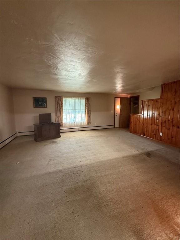 318 Hamburg Rd, Hempfield Twp Mer, PA 16125 - unfurnished living room featuring a baseboard heating unit, wooden walls, and carpet flooring