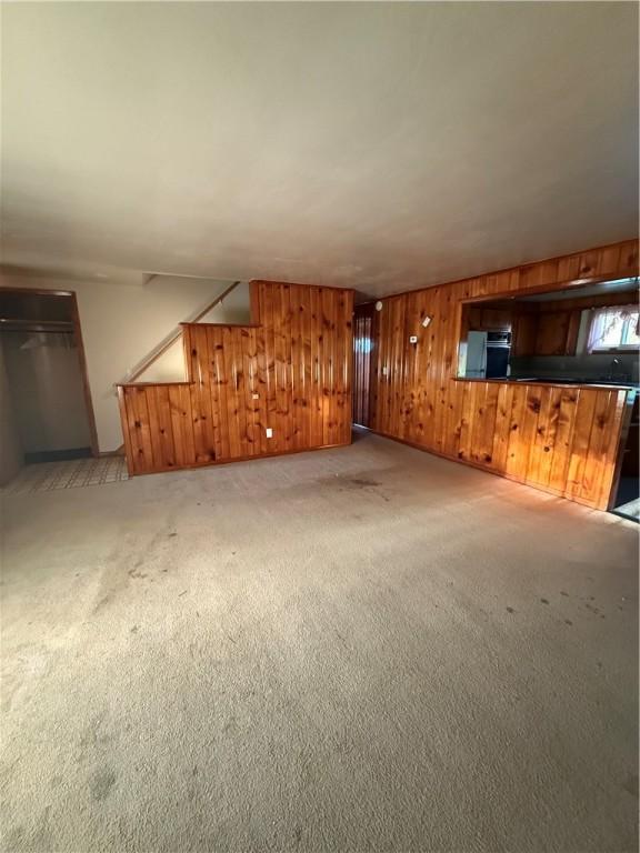 318 Hamburg Rd, Hempfield Twp Mer, PA 16125 - unfurnished living room featuring wooden walls and light carpet