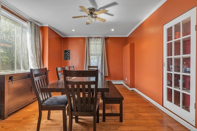 dining space featuring a baseboard radiator, light wood-type flooring, recessed lighting, ornamental molding, and a ceiling fan