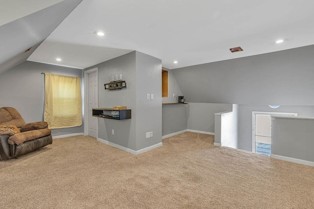 carpeted living area featuring recessed lighting, lofted ceiling, and baseboards