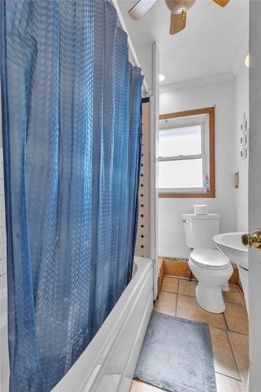 bathroom with tile patterned floors, shower / bathtub combination with curtain, ceiling fan, and toilet