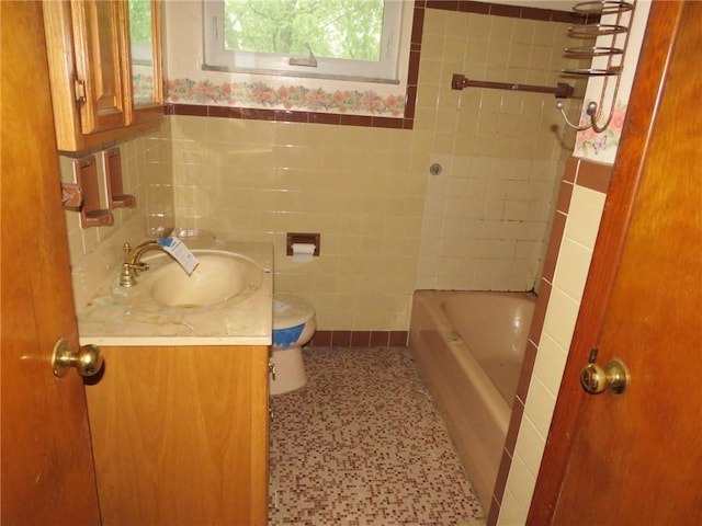 1185 Colgate Dr, Monroeville, PA 15146 - bathroom featuring tile walls, vanity, a bath, and wainscoting