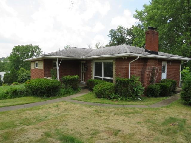 1185 Colgate Dr, Monroeville, PA 15146 - ranch-style home with a chimney, brick siding, and a front lawn