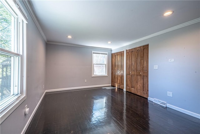 215 Wyngate Rd, Moon/Crescent Twp, PA 15108 - unfurnished bedroom featuring crown molding, visible vents, baseboards, multiple closets, and dark wood finished floors