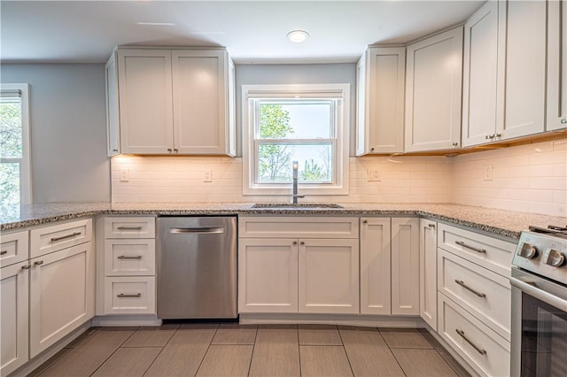 215 Wyngate Rd, Moon/Crescent Twp, PA 15108 - kitchen with light stone countertops, a sink, appliances with stainless steel finishes, and tasteful backsplash