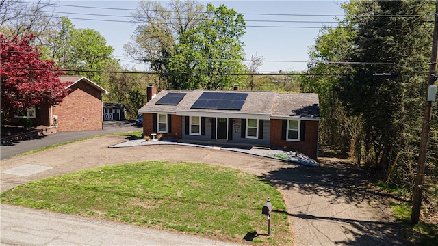 215 Wyngate Rd, Moon/Crescent Twp, PA 15108 - ranch-style house featuring a porch, brick siding, a chimney, solar panels, and curved driveway