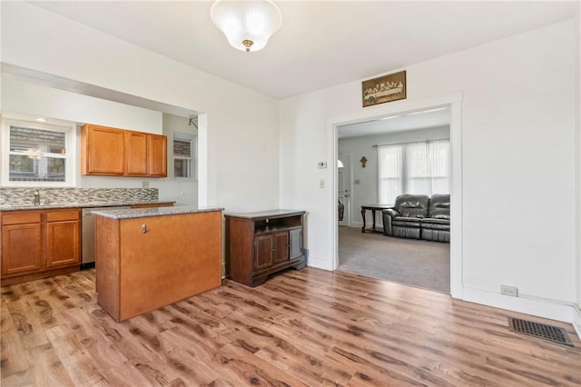 1163 Chislett, Morningside, PA 15206 - kitchen featuring brown cabinetry, light wood-type flooring, dishwasher, a sink, and visible vents