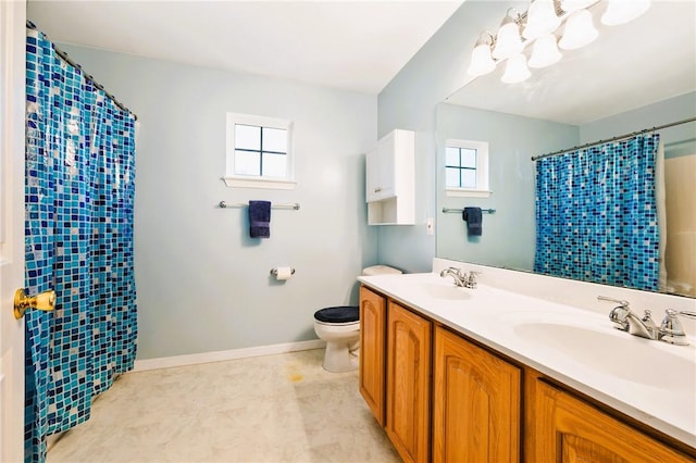 bathroom featuring a sink, curtained shower, toilet, double vanity, and baseboards