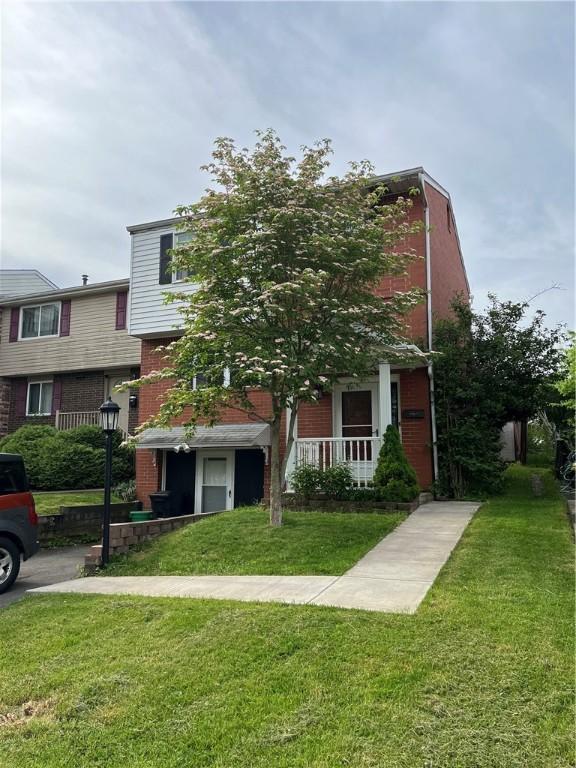 225 Jefferson Ave, Masontown, PA 15461 - view of front of property with brick siding and a front lawn
