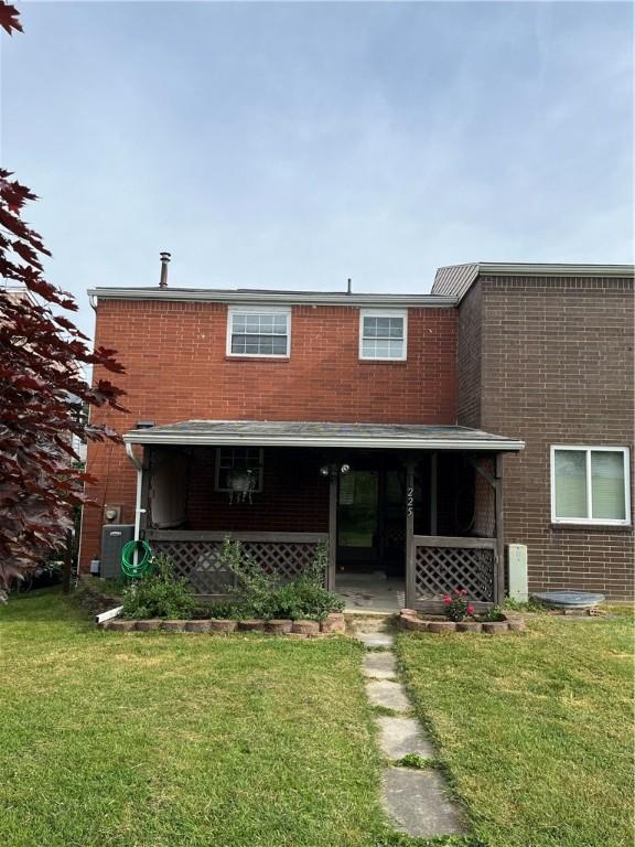225 Jefferson Ave, Masontown, PA 15461 - view of front facade with a front yard and brick siding