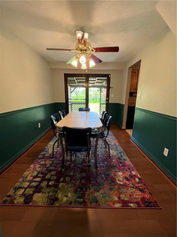 225 Jefferson Ave, Masontown, PA 15461 - dining space featuring wainscoting, wood finished floors, a ceiling fan, and a textured ceiling