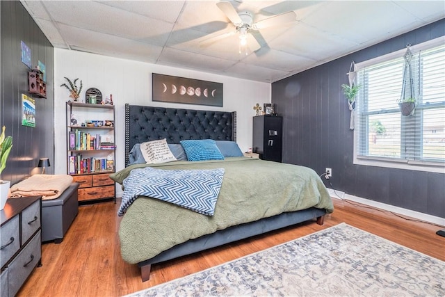 337 Whitestown Rd, Twp Of But Nw, PA 16001 - bedroom with ceiling fan, baseboards, wooden walls, wood finished floors, and a paneled ceiling