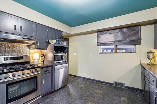 2364 Sheffield Rd, Aliquippa, PA 15001 - kitchen featuring appliances with stainless steel finishes, visible vents, dark countertops, under cabinet range hood, and backsplash