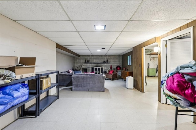 2364 Sheffield Rd, Aliquippa, PA 15001 - living area with light floors, wooden walls, a fireplace, and a drop ceiling