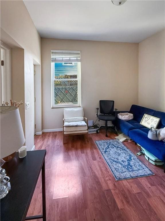 living room featuring baseboards and wood finished floors