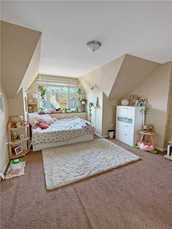 carpeted bedroom with lofted ceiling and baseboards