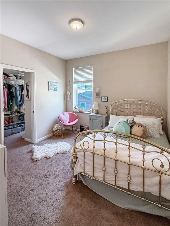 bedroom featuring carpet and baseboards