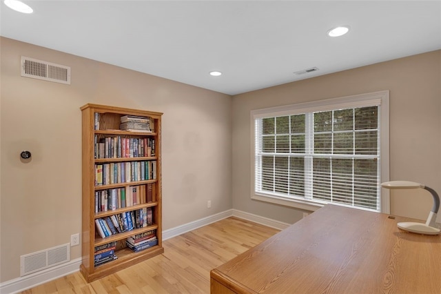 office featuring visible vents, wood finished floors, and baseboards