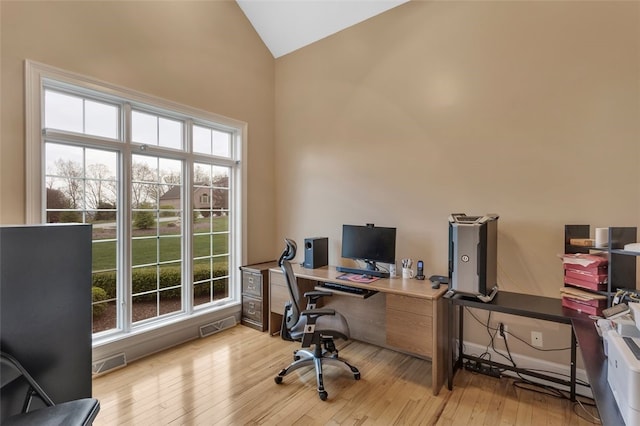 office space with visible vents, a wealth of natural light, and light wood-style flooring