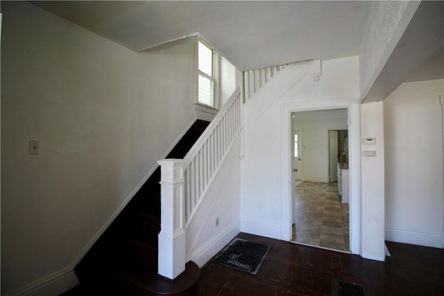 stairway with visible vents and baseboards