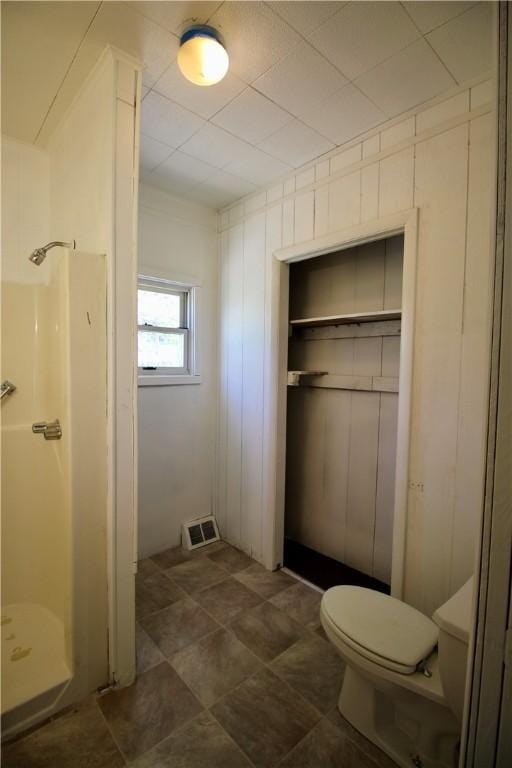 bathroom with visible vents, a shower stall, and toilet