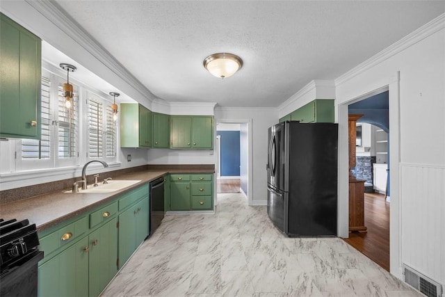kitchen with a sink, visible vents, green cabinets, black appliances, and ornamental molding