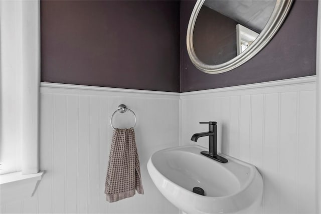 bathroom with wainscoting and a sink