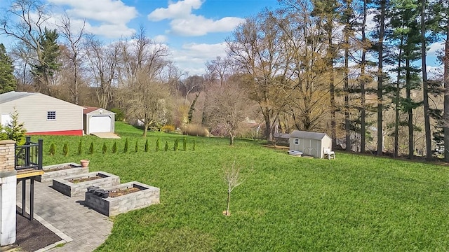 464 Crescent Blvd, Moon/Crescent Twp, PA 15046 - view of grassy yard with a detached garage, a garden, and view of scattered trees