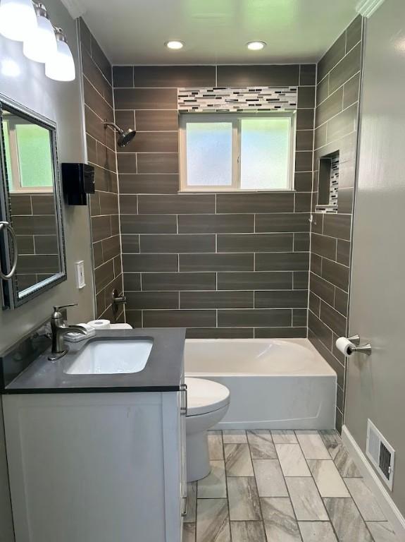 full bathroom featuring recessed lighting, vanity, shower / bath combination, toilet, and visible vents