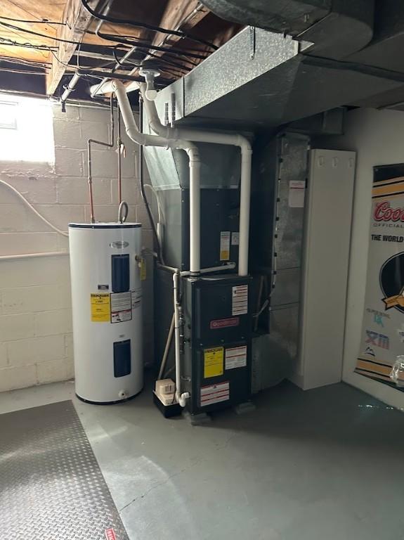 utility room featuring heating unit and water heater