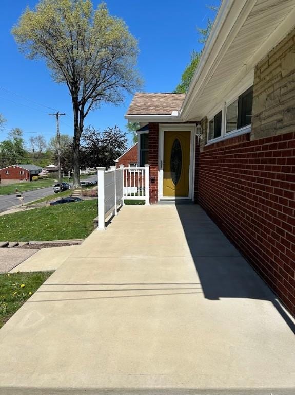 doorway to property with brick siding