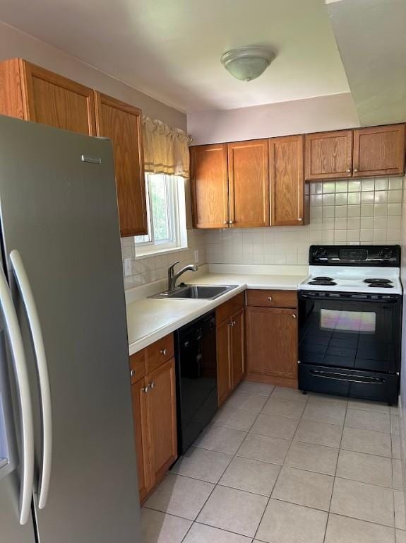 kitchen featuring stainless steel fridge with ice dispenser, brown cabinets, electric range oven, dishwasher, and a sink