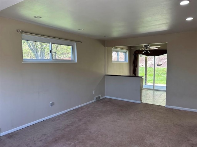 carpeted spare room featuring visible vents, a ceiling fan, recessed lighting, and baseboards