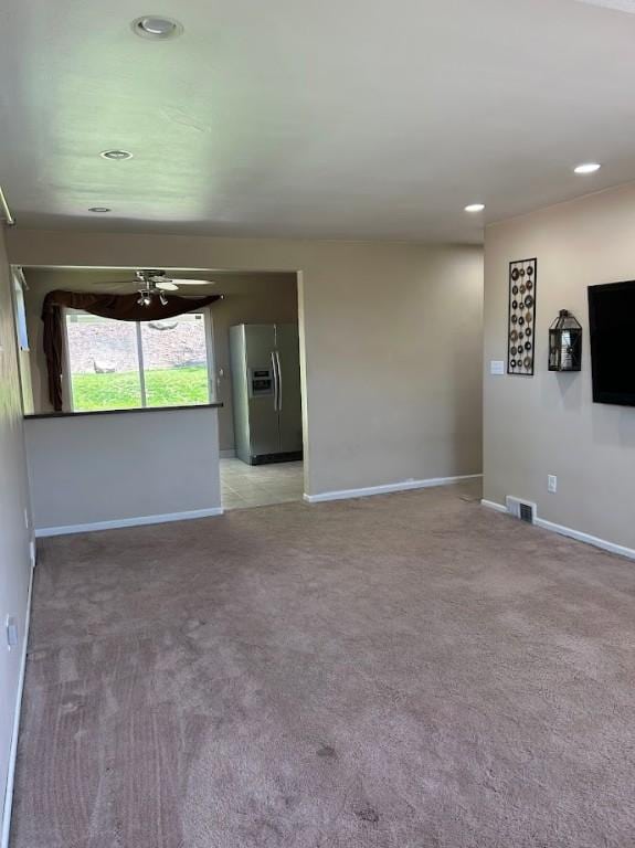unfurnished room with light colored carpet, visible vents, and baseboards