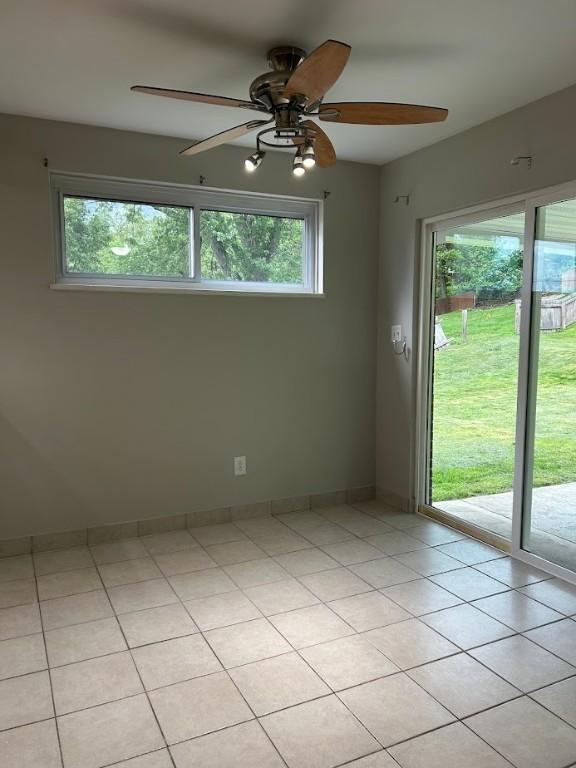 416 Millers Ln, Plum Boro, PA 15239 - spare room featuring healthy amount of natural light, ceiling fan, light tile patterned floors, and baseboards