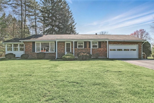 ranch-style house with driveway, a front lawn, brick siding, and an attached garage