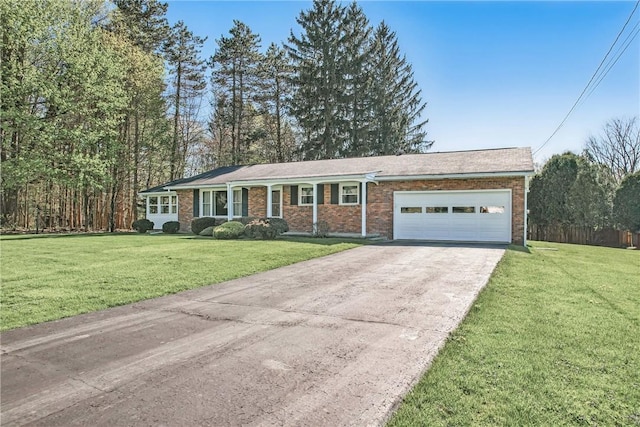 ranch-style house featuring brick siding, a front yard, concrete driveway, and an attached garage