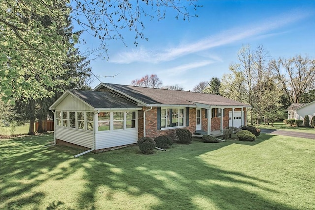 view of front facade featuring a front lawn, an attached garage, and brick siding