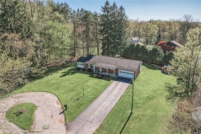 birds eye view of property featuring a view of trees